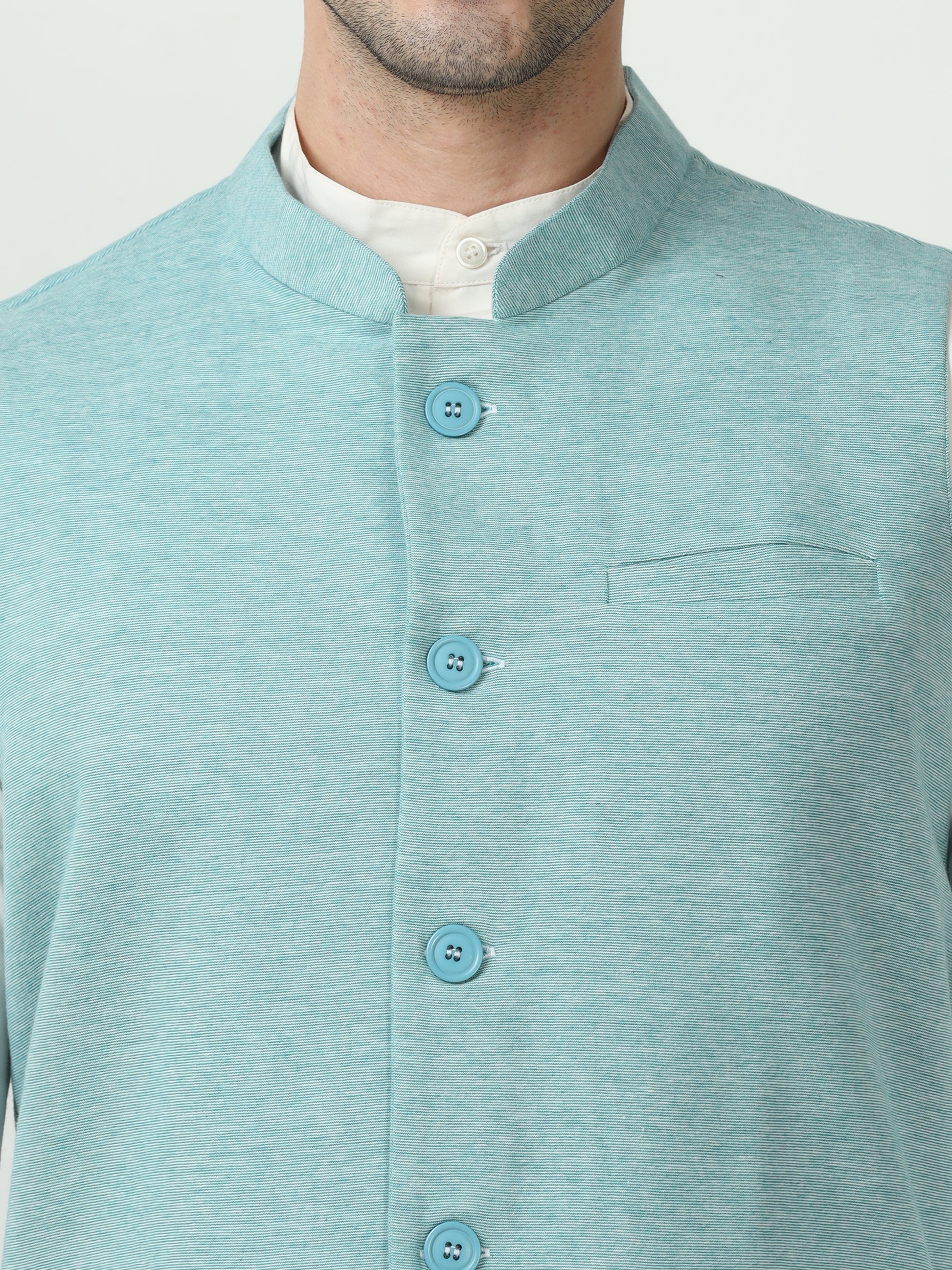 Button-front detailing on Sustainable Cotton Modi Coat Jade
