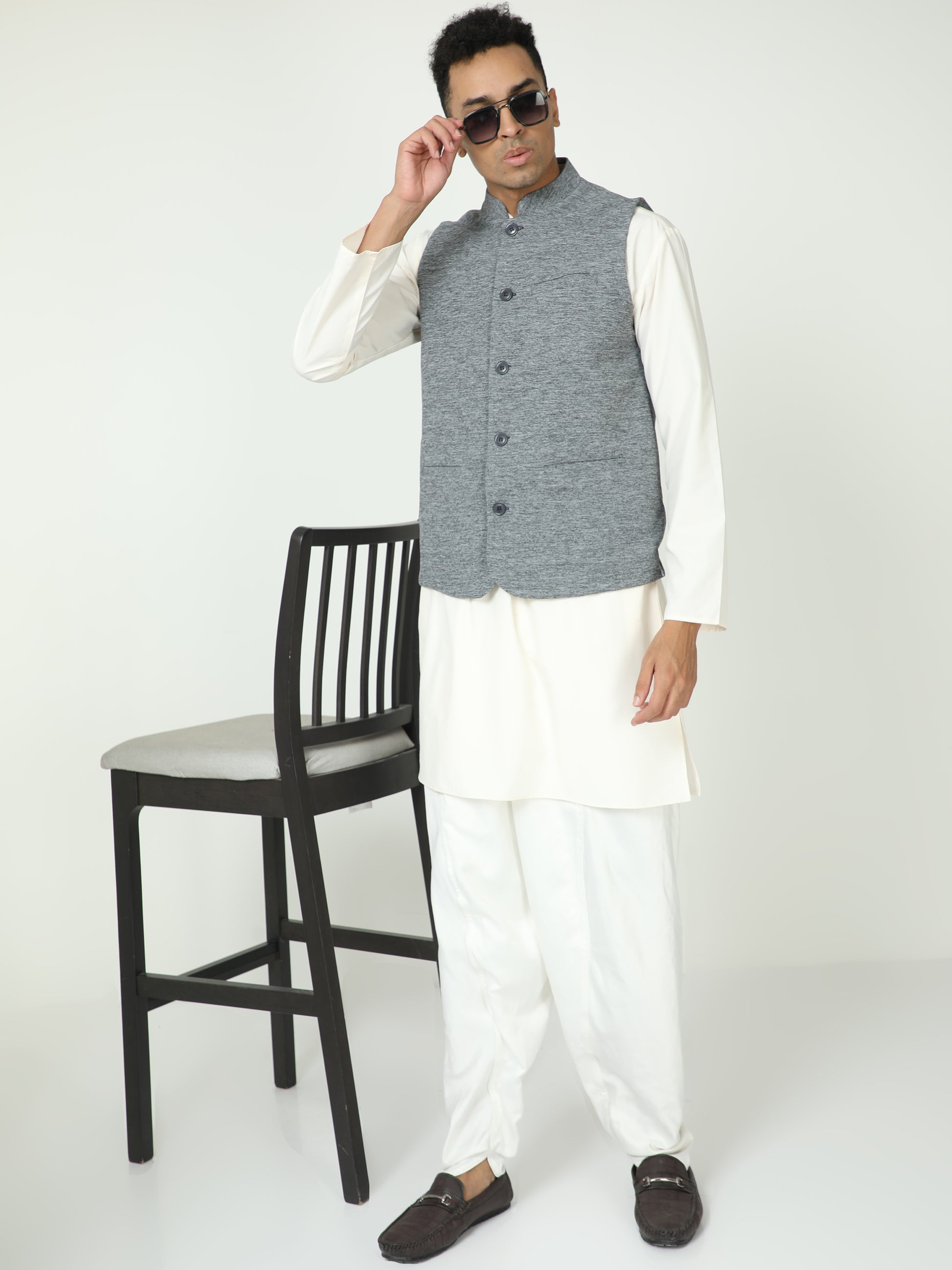 Side angle of model in Black Melange Modi Jacket paired with kurta